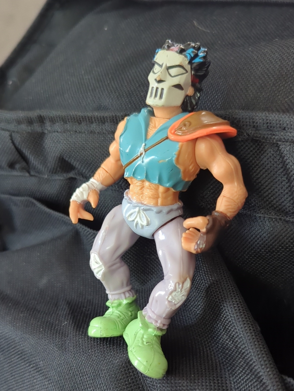Masked Action Figure with Blue Vest and Green Shoes